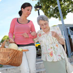 A carer helps her loved one with shopping.