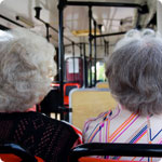 Two older ladies sitting on a bus.