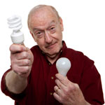 A older man chooses an energy efficient bulb.