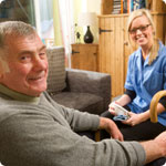 A older man with his care home nurse.