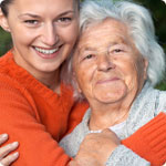 A lady is hugging her mother.